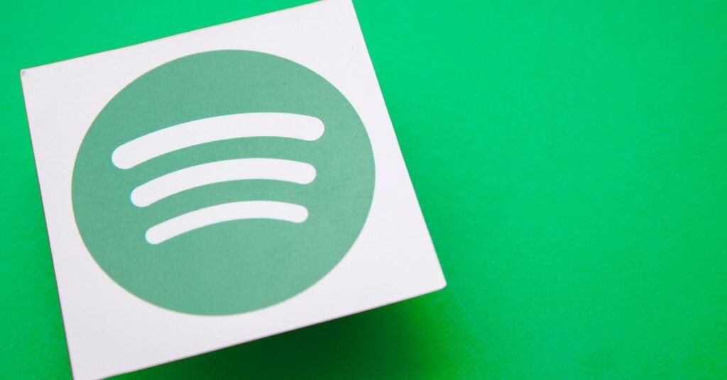 White square with Spotify logo (green circle, three white curved lines) on a vibrant green background.