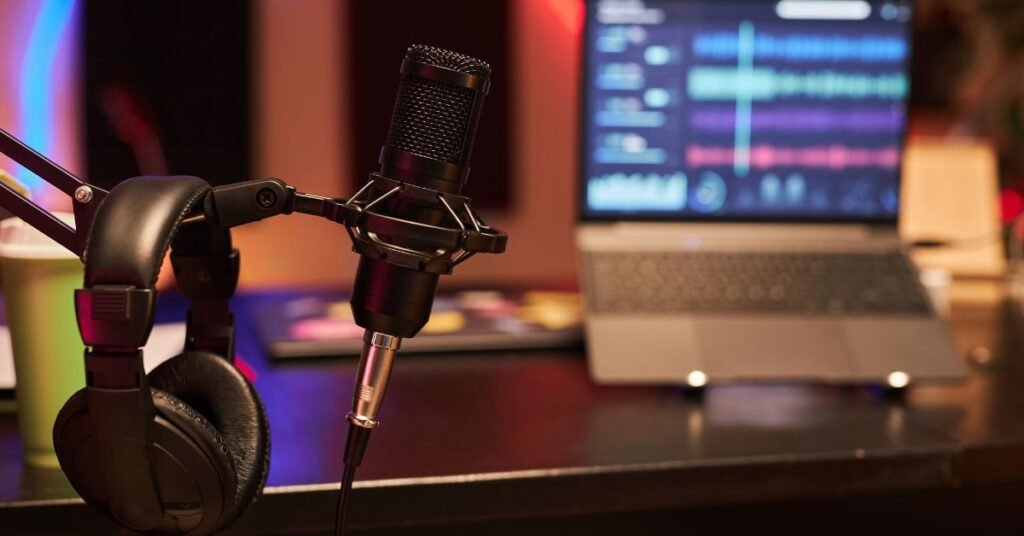 Best Day to Release a Podcast in 2025 Podcast setup with a mic, headphones, and a laptop.