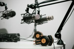 Professional podcast recording setup with microphones and headphones. 